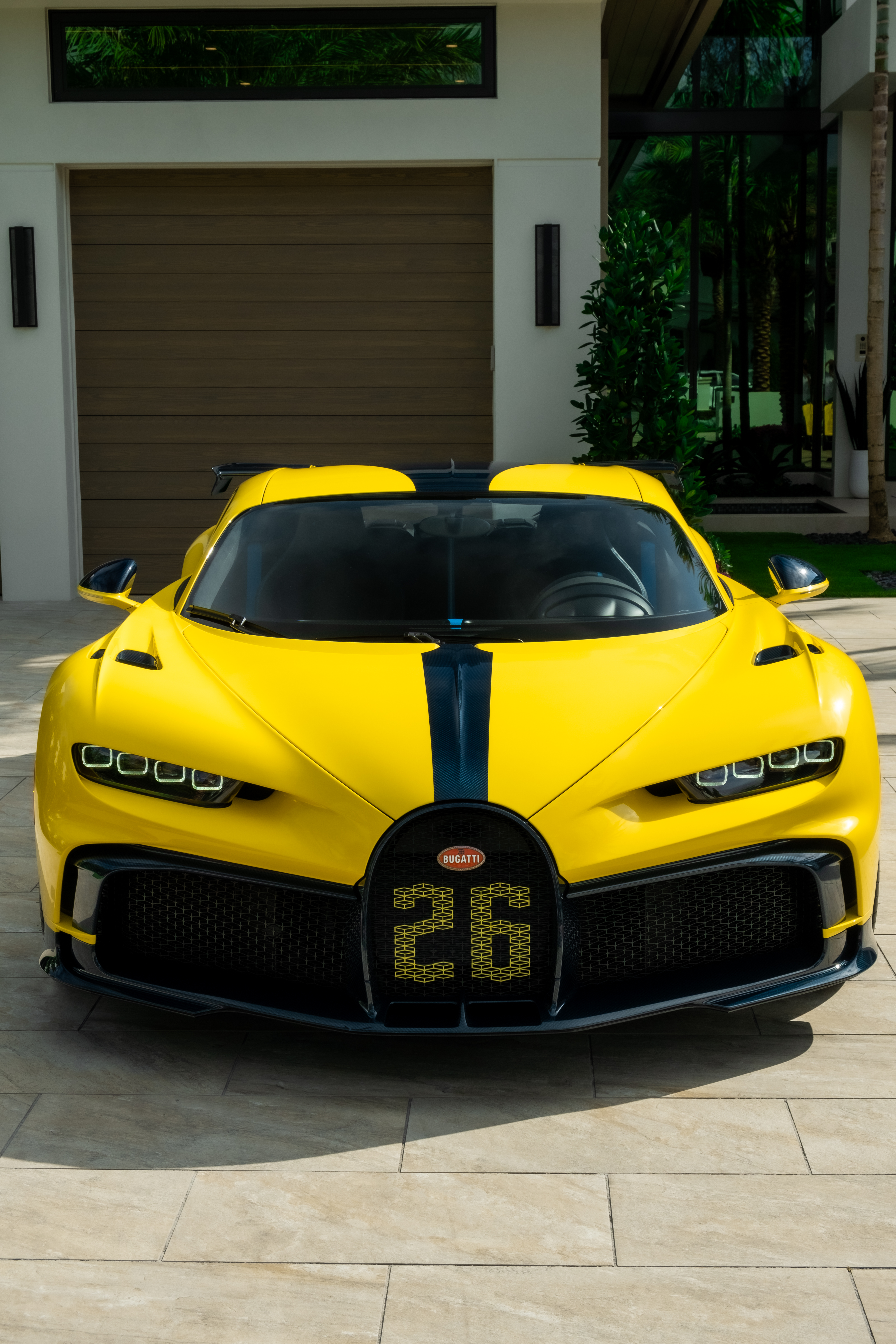 “Ferrari logo close-up on carbon fiber hood during luxury automotive photo session.”